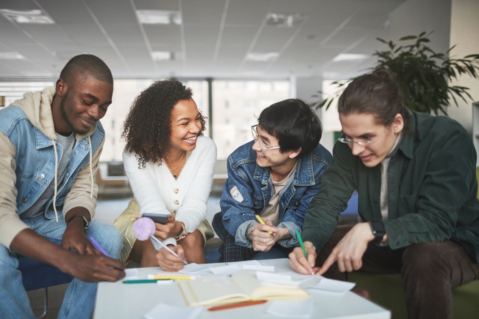 University students collaborating around a laptop